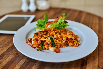 Asian or Chinese noodles with chicken noodles and vegetables.