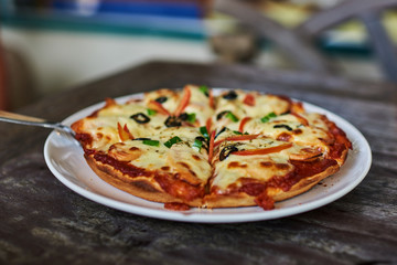 Pizza with ham, pepper and olives.