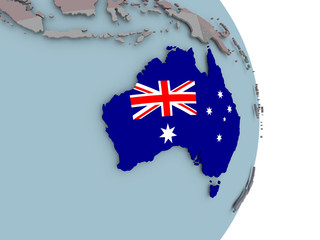 Map of Australia on political globe with flag