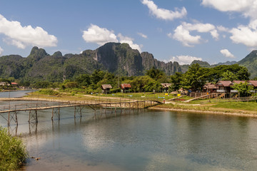 Fototapeta premium The beautiful landscape with bamboo bridge on the Nam Song river in Vang Vieng, Laos