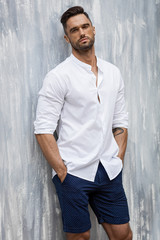 Handsome man in white shirt and shorts
