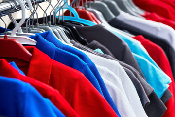 Colorful polo t-shirt for the man on hangers in a retail shop