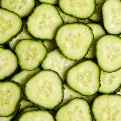 Green slices of cucumber as background