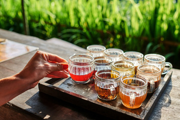 Coffee with multiple assorted types and flavors of coffee and tea in identical mugs for degustation...