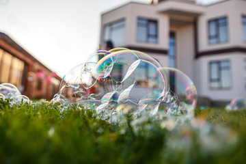 large bubbles are lying on the green grass