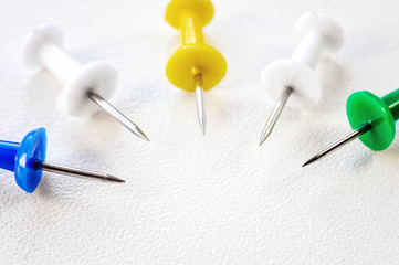 Multicolored clerical needles, needles on white background