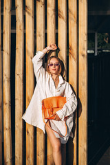 Fashionable pretty woman posing outdoor on the street