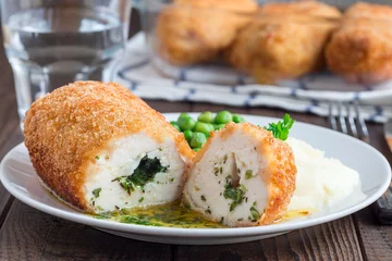 Furniture stickers Kiev Chicken Kiev, ukrainian cuisine. Cutted chicken cutlet in bread crumbs stuffed with butter and herbs, served with mashed potato and green peas, on brown background, horizontal