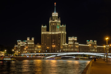 Moscow city landscape with night view on skyscraper on embankment river.