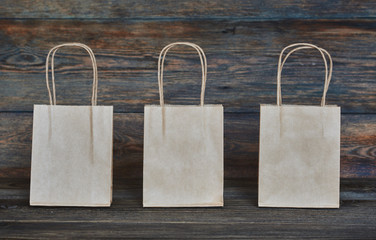 Mock-up of brown craft paper package with handles, empty shopping bag with area for your logo or...