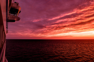 Cruise ship sailing into sunrise