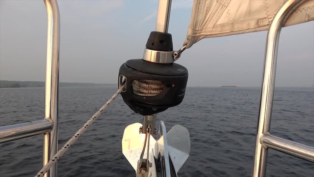 Footage taken from sailboat bow showing modern pulley is wheel on an axle that is designed to support movement and change of direction of taut cable and transfer power between the shaft 4k quality