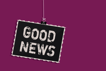 Word writing text Good News. Business concept for Someone or something positive,encouraging,uplifting,or desirable Hanging blackboard message communication information sign purple background.