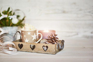 Christmas composition. Winter hot drink. Christmas hot chocolate or cocoa with marshmallow on white background with christmas decorations candles, lights, cones. Christmas, winter and holiday concept.