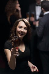Plakat happy young woman raising a glass of champagne