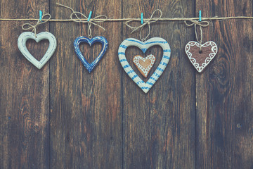 Wooden hearts on the brown wooden table. Christmas background.