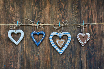 Hearts on a twine on rustic wooden background. Christmas background. Top view with copy space.