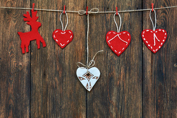 Red hearts, white hearts  and  reindeer with clothespins. Image of Christmas holidays season.