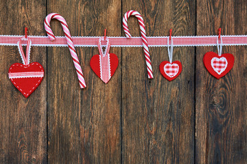 Christmas Candy Canes with Christmas decoration on old wooden boards.