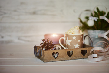 Christmas composition. Winter hot drink. Christmas hot chocolate or cocoa with marshmallow on white background with christmas decorations candles, lights, cones. Christmas, winter and holiday concept.