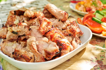 Grilled pork on a white plate
