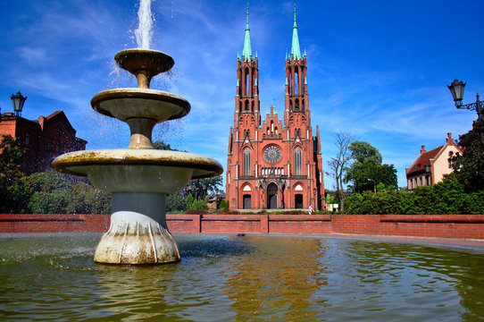 Church and fountain in Żyrard&oacute;w