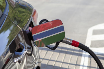 Fueling car with petrol pump at a gas station.