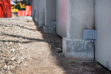 Industrial construction site of new shopping mall in a city. Reinforced concrete piles foundation for the building. Freshly made grouting base pole for block building