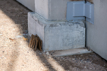 Industrial construction site of new shopping mall in a city. Reinforced concrete piles foundation for the building. Freshly made grouting base pole for block building
