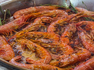 Shrimps prawns fried with spices. Shrimps Prawns are fried in a large frying pan, the chef prepares the prepared shrimp. Fried shrimp in a frying pan. Seafood Preparation. Roasted shrimps with herbs.