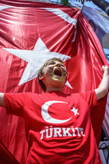 Obraz premium Boy and Waving National Turkey Flag of Silk