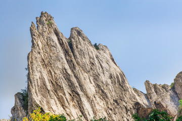 Mountain range with blue sky background in Cheile Turzii, Romania
