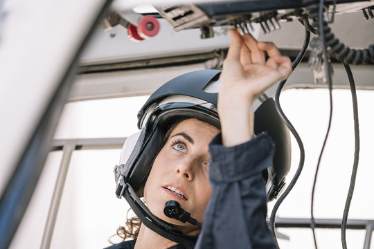 Pilot woman inside a helicopter