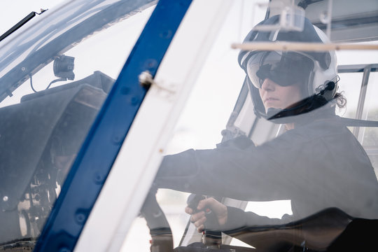 Pilot woman inside a helicopter