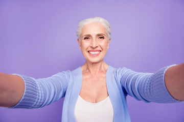 Self portrait of gray haired beautiful smiling old lady wearing 