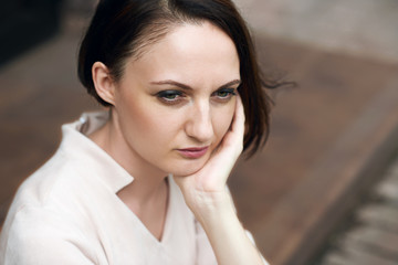 Naklejka premium young girl sitting in the street and dreams