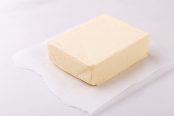 Stick of butter. Cutting board, dairy products