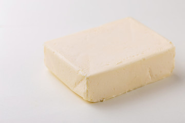 Stick of butter. Cutting board, dairy products
