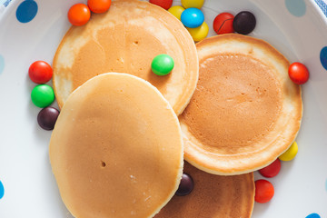 Children's breakfast or dessert - pancake with colorful candies.