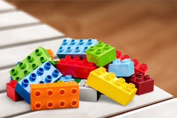 Colorful children building bricks on background