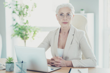 Gray-haired beautiful stylish old serious self-confident lady of