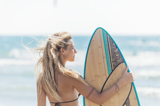 A Woman Surfer Standing at Beach