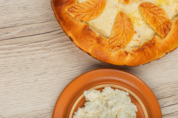 Home-made curd cake on a wooden background with ingredients.