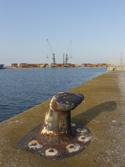 Obraz na płótnie Canvas Mooring point at the port in the foreground and an industrial port in the background