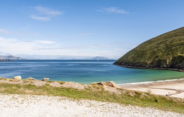View of the beautiful Keem Bay on Achill Island in Ireland. Sandy beach, calm ocean, tall cliffs...