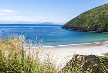View of the beautiful Keem Bay on Achill Island in Ireland. Sandy beach, calm ocean, tall cliffs...