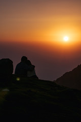 Fototapeta premium A couple who watching sunset on the mountain