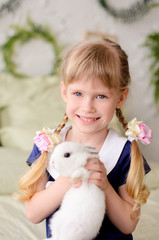 beautiful girl  holding a white rabbit