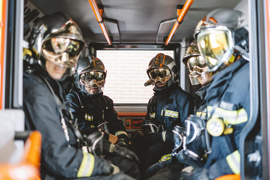 Unrecognizable Firemen With Helmet In An Emergency Vehicle