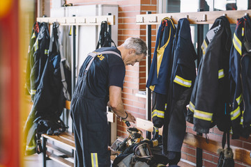 Firemen getting dress at looker room in fire station
